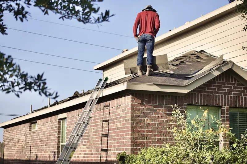 Professional roofer working on a residential roof in Knauers